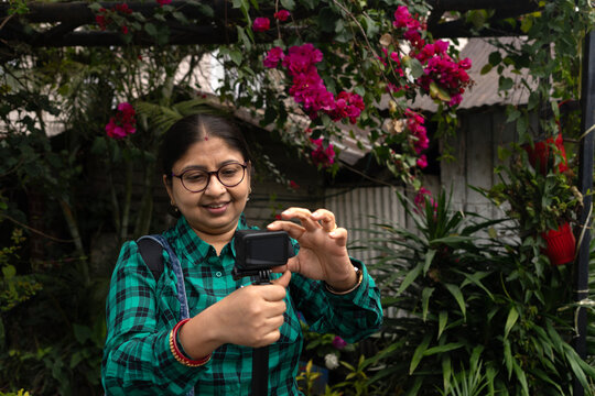 Indian woman doing videography in a winter morning