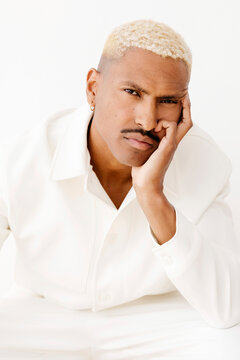 Man resting chin on hand looking serious
