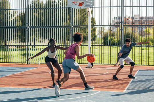 Intense basketball game on an outdoor court