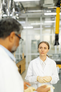 Two scientists young woman and Indian man in real laboratory