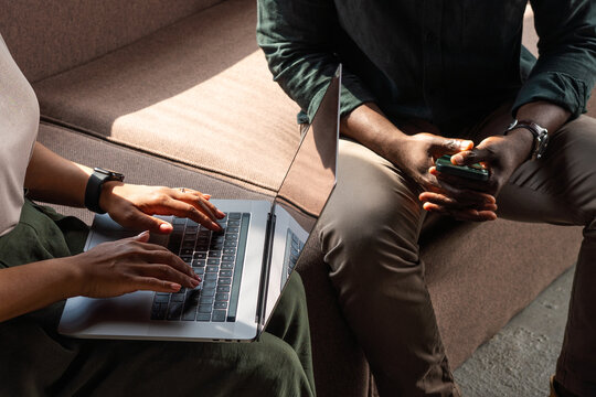 Two Anonymous Colleagues Collaborating on Laptop Hands Close Up