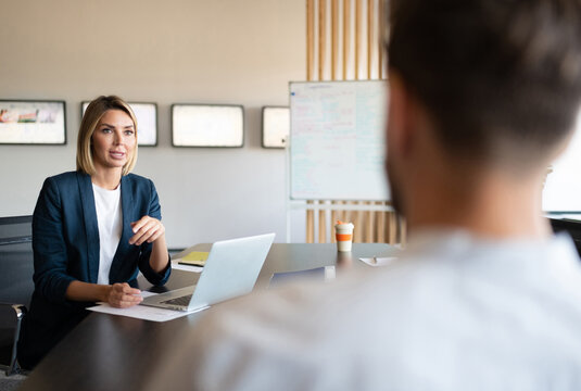 Businesswoman talking with colleague during meeting