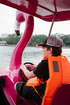 Bright Pink Flamingo Pedal Boat Ride Brings Joy to Young Adventurer