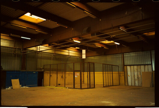 Empty warehouse interior with fenced enclosure