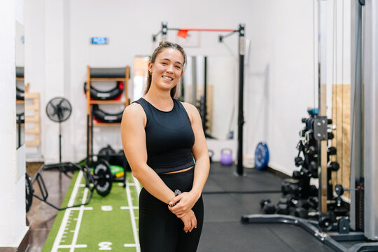 Smiling woman personal trainer in functional gym studio