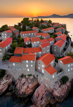 Sunset over Sveti Stefan island architecture, aerial shot