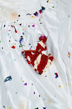 cake and confetti scattered on the lap of a bride