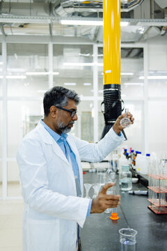  Indian scientist in white coat working in laboratory