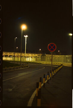 Curved road with no stopping sign at night