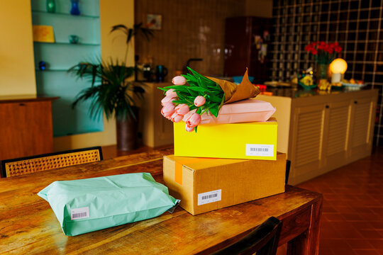 Home delivery packages and fresh flowers arriving ugc