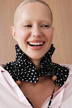 Joyful woman portrait in polka dot scarf