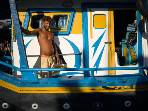 Sri Lankan Fisherman Beside Boat in Harbor