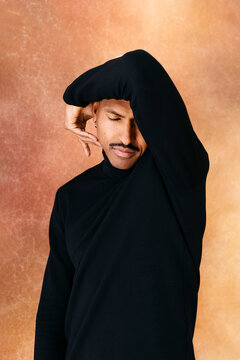 Man posing with hand gesture on face