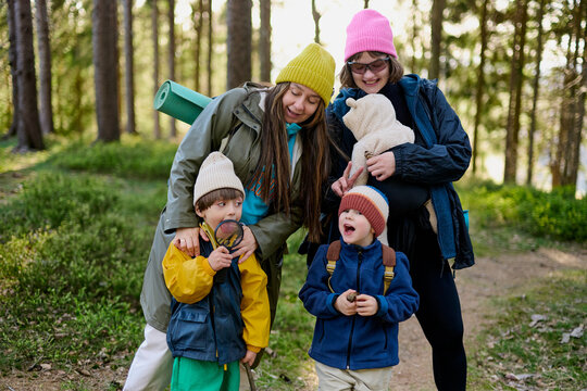 Happy family with kids posing during forest hike