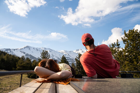Friends Relax on camper van roof view