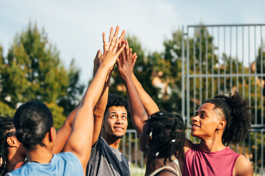 Diverse group of friends celebrates with a high five