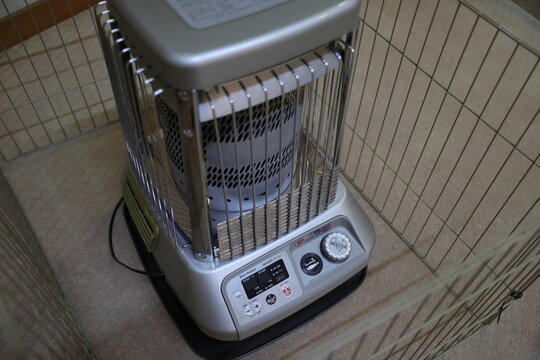 A Japanese kerosene heater protected by a safety wire guard.
