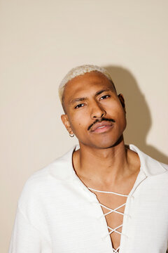Man with bleached hair looking at camera