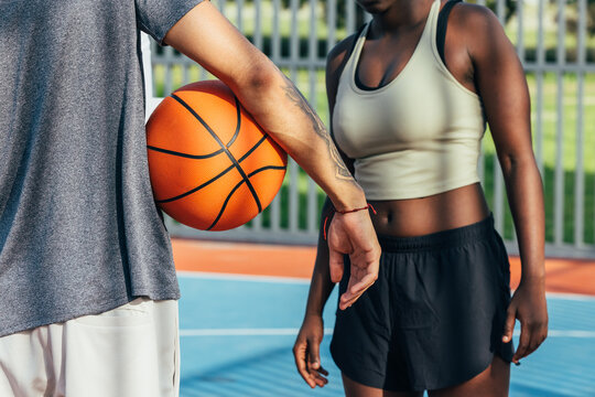 Basketball practice with two athletes on outdoor court
