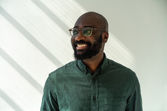 Smiling Black Man Wearing Glasses and Green Shirt 