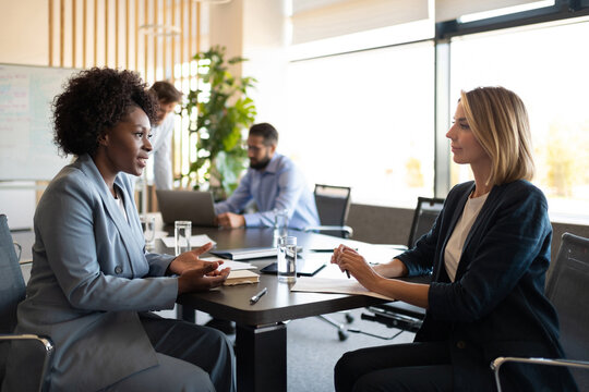 Diverse female managers talking about business