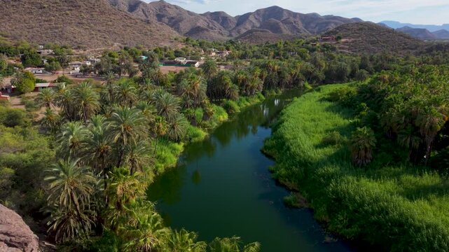 See the beautiful aerial views of the overlook at the church Mission of Santa Rosalia surrounded by mountains and a lush oasis in Mulege, Mexico.