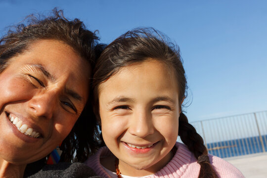 Smiling Mother and Daughter Take Selfie 