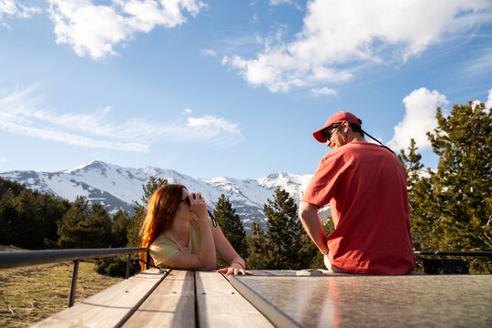 Couple on camper van deck enjoy view