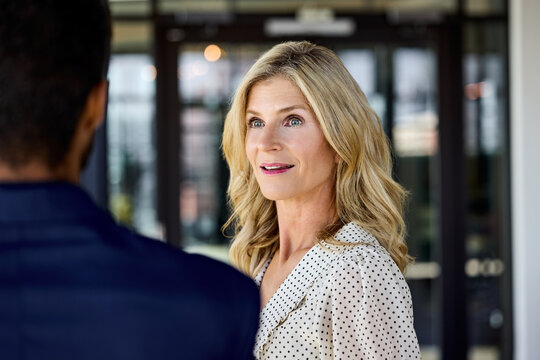 Woman Talks to Man in a Modern Office