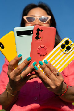 Woman holding multiple phones outdoor lifestyle