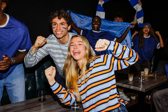 Diverse friends celebrating sport victory feeling excitement