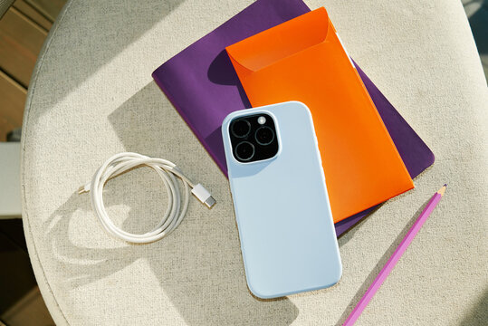 a telephone, a notebook and wires in the sunlight