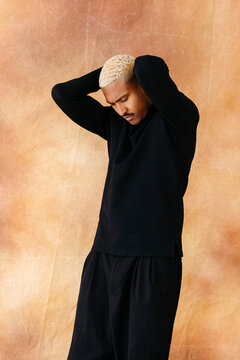 Man holding head in black top