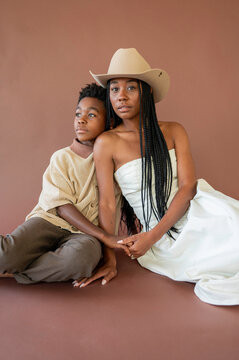 Mom and Son Pose Together With Warm Smiles in Studio Setting