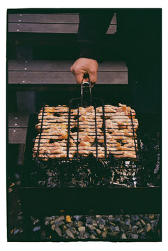 Hands hold bowl of cooked meat pieces