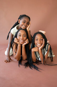 Three Girls Enjoy Time Together in a Warm Setting With Smiles
