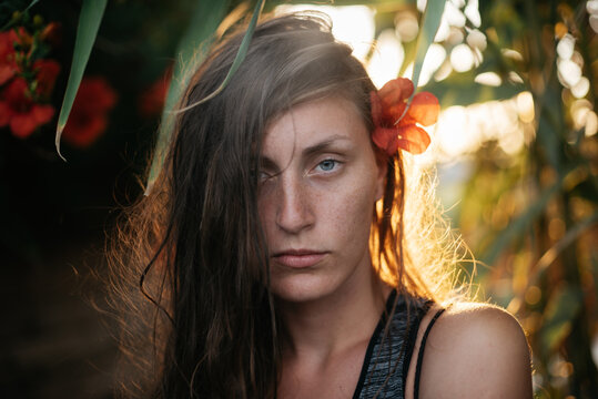 Close portrait with flower in hair
