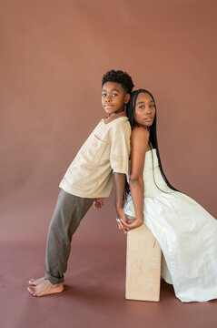 Mom and Dad Pose Together on a Simple Background for a Photo Shoot