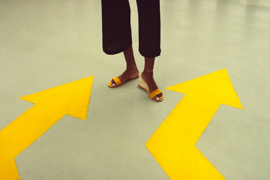 Feet Between Yellow Arrows