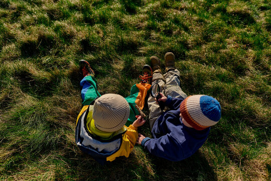 Kids exploring nature with magnifying glass