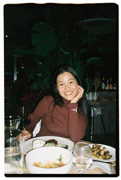 Smiling Woman Drinking Wine at Restaurant