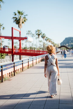 Back view of a woman walking in the city