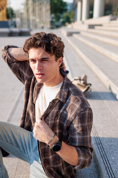 Young man wiping sweat during extreme urban heatwave