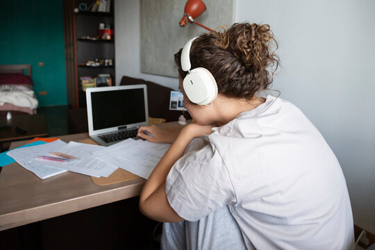 Person remote learning at home wearing headphones
