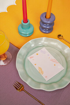 Ceramic plate on festive table serving with invitation card mock up
