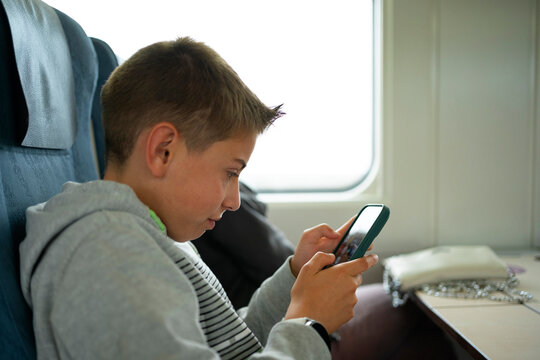 Passenger Using Smartphone On a train