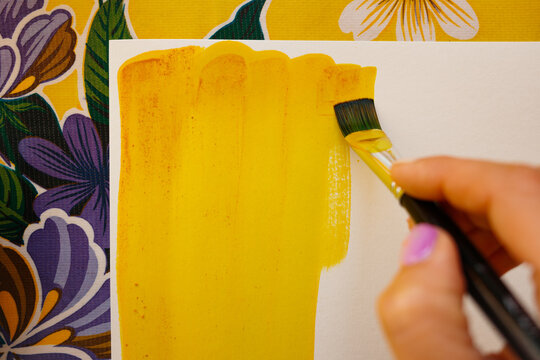 Hand Painting with Yellow Brush on Canvas