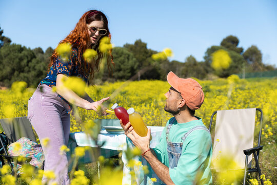 Friends Sharing Drinks At Picnic