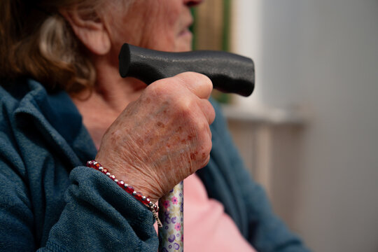 Close up of elderly hand holding walking cane