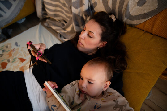 Woman and baby together at home on sofa
